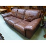 A brown leather three seater settee