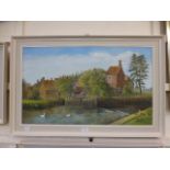 A framed oil on canvas of swans on river