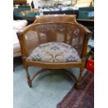 An early 20th century walnut tub chair,