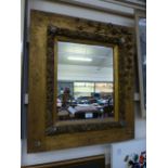 A floral gilt framed rectangular mirror