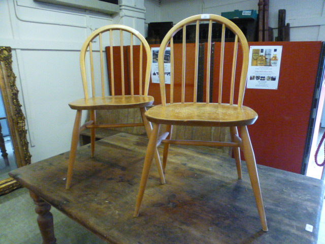 A pair of light Ercol hoop back chairs