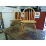 A pair of light Ercol hoop back chairs