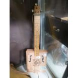 A reproduction cigar box banjo