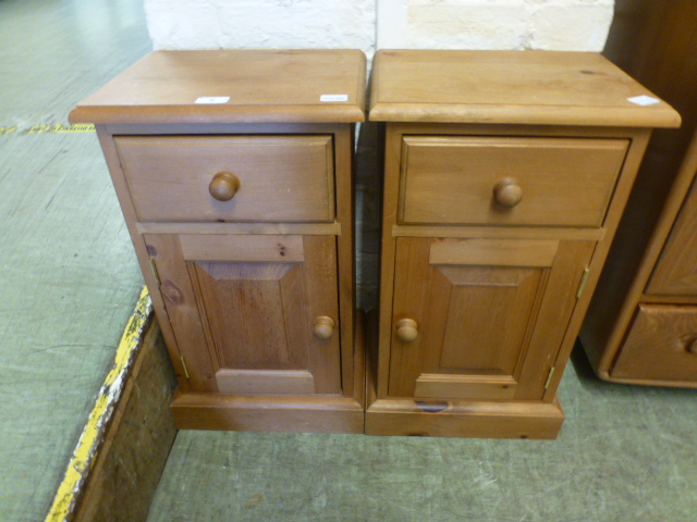 A pair of pine bedside cabinets having a