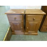 A pair of pine bedside cabinets having a
