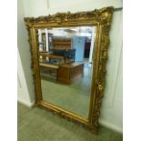 A large ornate gilt framed bevel glass m