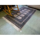 A hand woven Afghan rug, the multi line