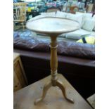 A modern oak candle stand with dish top