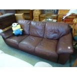 A brown leather upholstered three seat s