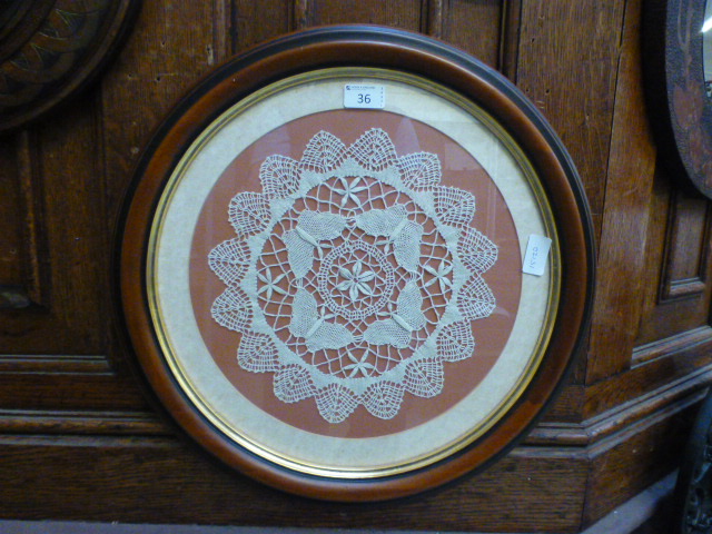 A framed and glazed example of lacework