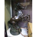 A large resin model of a rearing horse