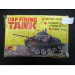 A mid-20th century cap firing toy tank b