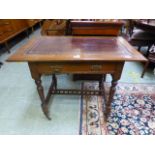 An Edwardian walnut writing table, the t