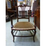 An Edwardian mahogany open armchair havi