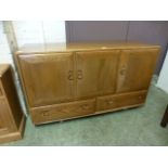 A light Windsor Ercol sideboard, three d