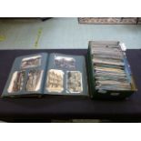 A box and album of postcards on various