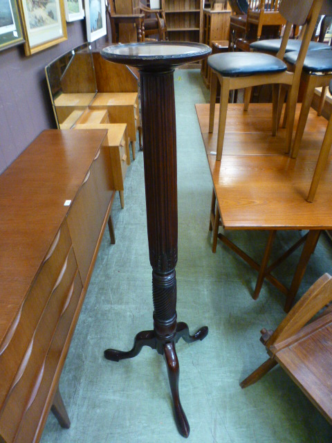 A reproduction mahogany jardiniere stand