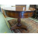 A reproduction mahogany drum table, the