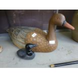 A large carved wooden duck together with