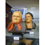Two carved wooden busts of elderly peopl