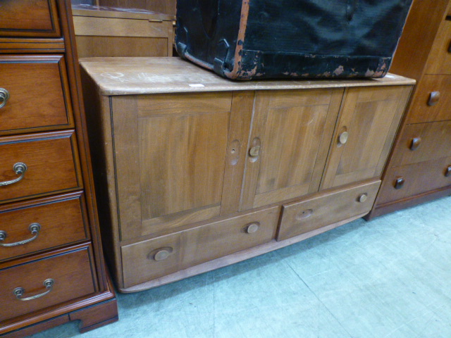 A light Ercol Windsor sideboard with thr