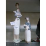 Two Lladro models of ladies holding anim