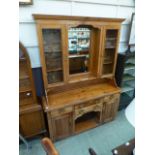 A pine dresser, the top with glazed cupb