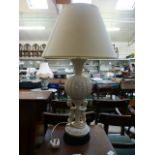 A white ceramic table lamp with cherub d