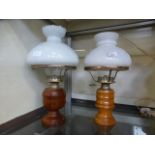 Two 20th century oil lamps having turned