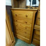 A modern pine chest of six long drawers