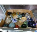 A small tray of assorted paperweights