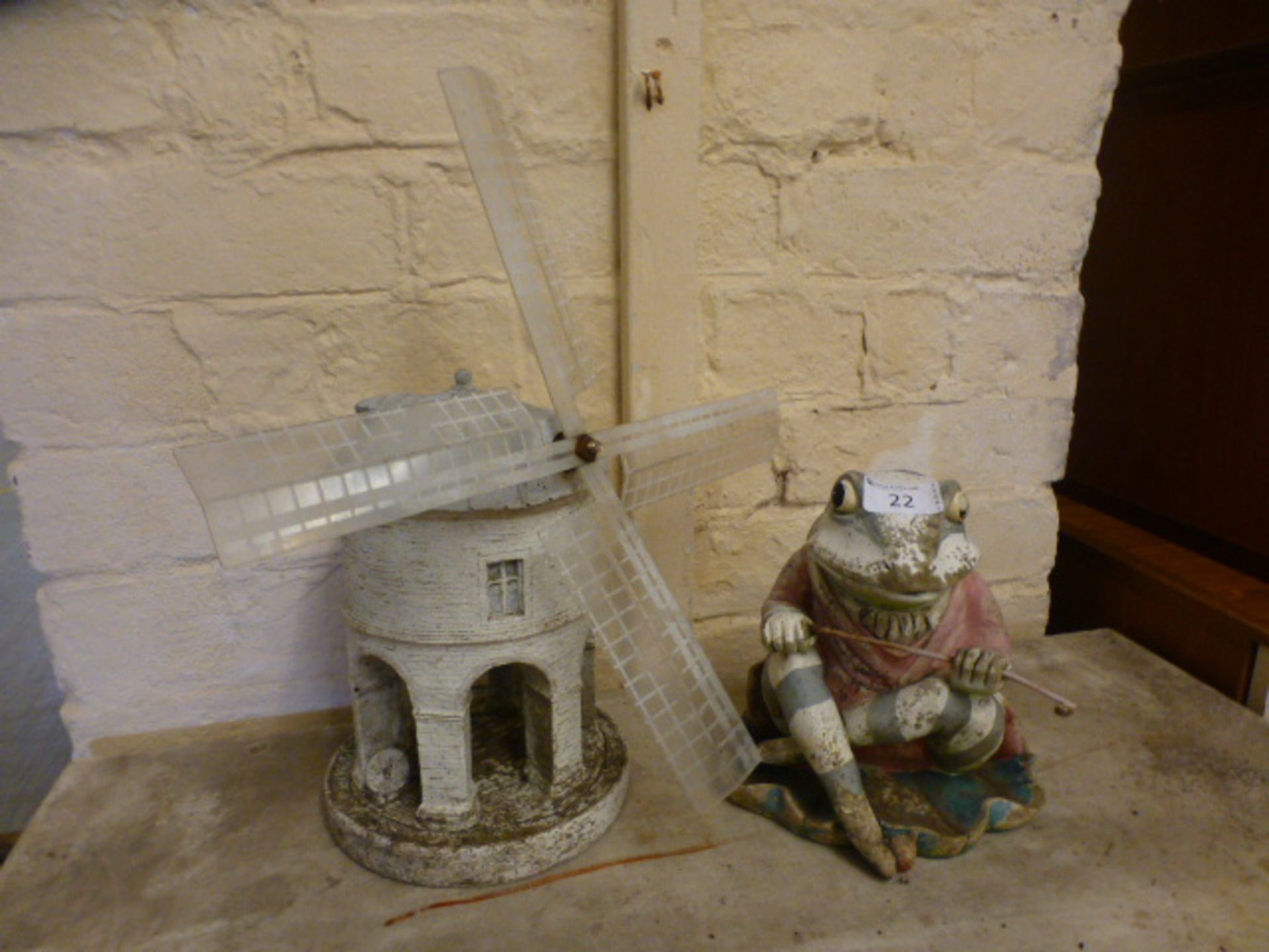 Two garden ornaments, one a sitting frog