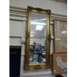 An ornate gilt framed rectangular mirror