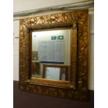 An ornate gilt framed rectangular bevel