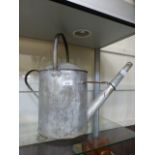 A galvanized watering can