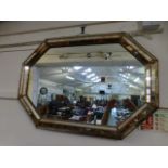 A modern cushioned edged wall mirror