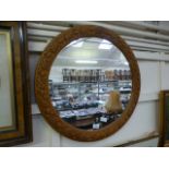 A circular carved pine mirror