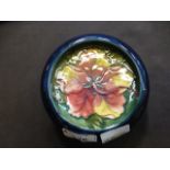 A Moorcroft bowl decorated on a blue gro