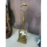 A brass door stop with galleon design