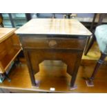 A mid-20th century side table with a sin