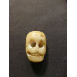 A carved bone memento mori