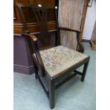 A Georgian mahogany open armchair having