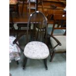 A dark Ercol rocking chair