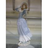 A Lladro figure of a lady in a hat