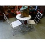 A metalwork folding bistro table with a