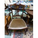 An Edwardian mahogany open armchair havi