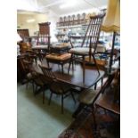 A dark Ercol refectory style dining tabl