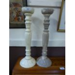 A pair of wooden painted candle sticks