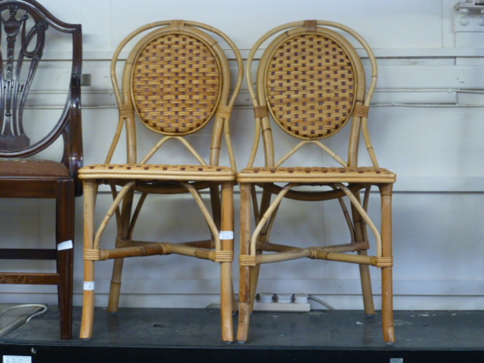 A pair of bamboo and wicker single chair