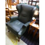 A green leather upholstered reclining wi